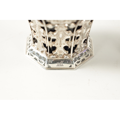 699 - A PAIR OF MID 19TH CENTURY SILVER SWEET BASKETS with rope twist handles and pierced repousse faceted... 