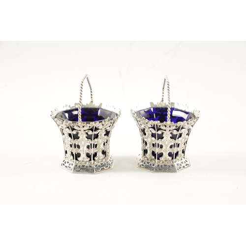 699 - A PAIR OF MID 19TH CENTURY SILVER SWEET BASKETS with rope twist handles and pierced repousse faceted... 