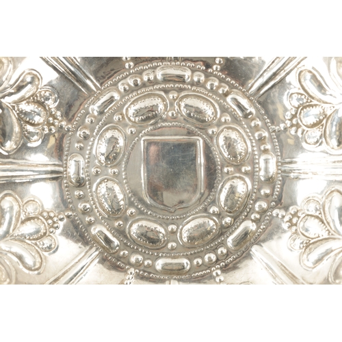 701 - A FINE WILLIAM III SILVER SWEETMEAT DISH of shallow petal shaped design with overall embossed decora... 