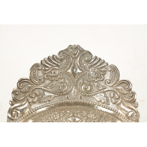 702 - AN EARLY 19TH CENTURY SOUTH AMERICAN SILVER DISH with embossed floral gallery and planished scallop-... 