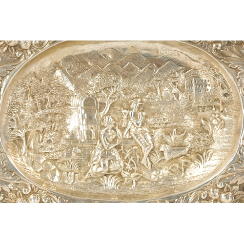 707 - AN 18TH CENTURY GERMAN REPOUSSE SILVER AND SILVER GILT OVAL CHARGER depicting a classical romantic g... 