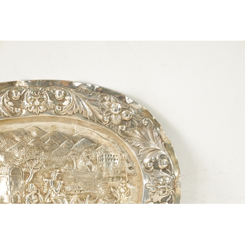 707 - AN 18TH CENTURY GERMAN REPOUSSE SILVER AND SILVER GILT OVAL CHARGER depicting a classical romantic g... 