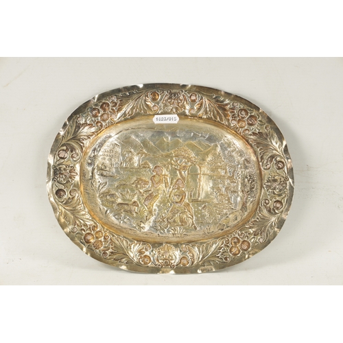 707 - AN 18TH CENTURY GERMAN REPOUSSE SILVER AND SILVER GILT OVAL CHARGER depicting a classical romantic g... 