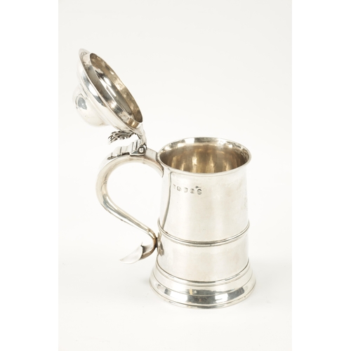 712 - A GEORGE III SILVER TANKARD of plain monogrammed tapering footed form with ribbed girdle, dome cover... 