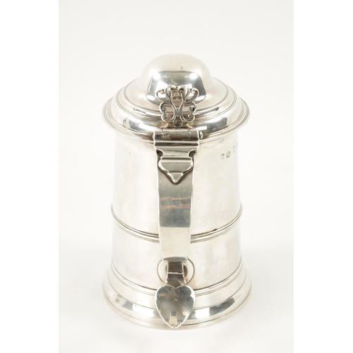 712 - A GEORGE III SILVER TANKARD of plain monogrammed tapering footed form with ribbed girdle, dome cover... 