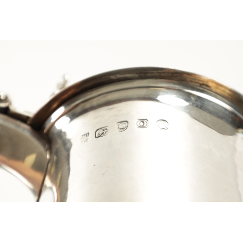 712 - A GEORGE III SILVER TANKARD of plain monogrammed tapering footed form with ribbed girdle, dome cover... 