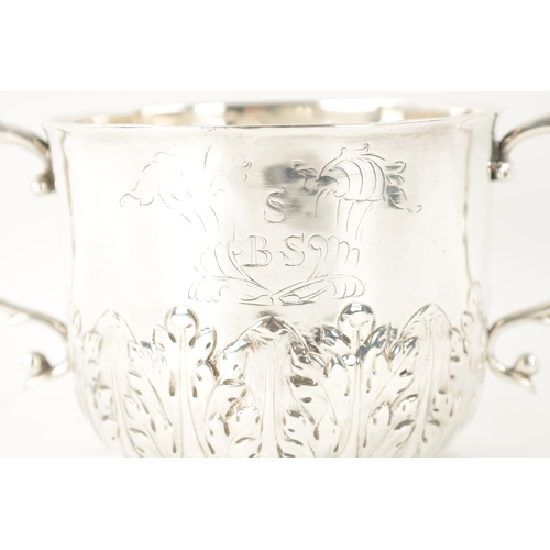 716 - A CHARLES II SILVER PORRINGER the monogrammed body with sprouting leafwork lower band and scrolled h... 