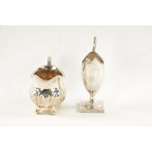 717 - A GEORGE III HELMET CREAM JUG AND MILK JUG the cream jug on a square foot by Walker George Giles (ov... 