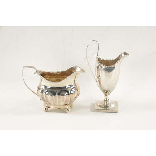 717 - A GEORGE III HELMET CREAM JUG AND MILK JUG the cream jug on a square foot by Walker George Giles (ov... 