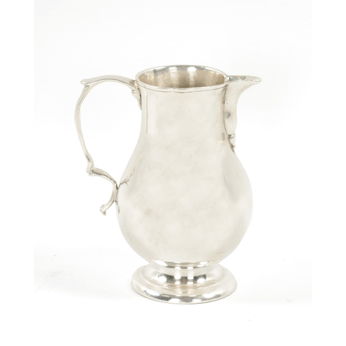 721 - AN EARLY GEORGIAN SILVER CREAM JUG of sparrow beak baluster form with scroll handle. Chester marks b... 