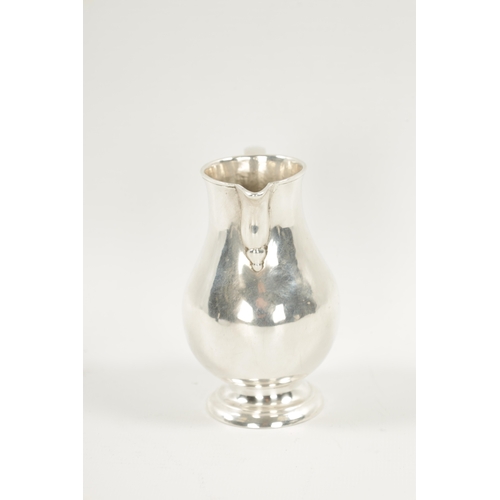 721 - AN EARLY GEORGIAN SILVER CREAM JUG of sparrow beak baluster form with scroll handle. Chester marks b... 