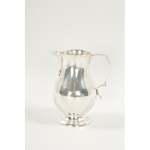 721 - AN EARLY GEORGIAN SILVER CREAM JUG of sparrow beak baluster form with scroll handle. Chester marks b... 