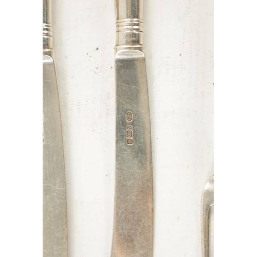 728 - A SET OF EDWARDIAN SILVER FRUIT KNIVES AND FORKS having pistol grips with silver blades and prongs. ... 