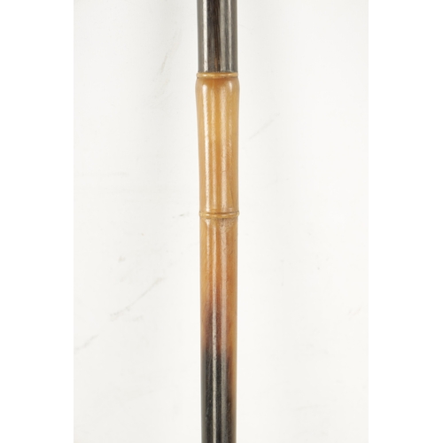 740 - A LATE 19TH CENTURY RHINOCEROS HORN WALKING STICK of turned tapered form with brass tip, total weigh... 