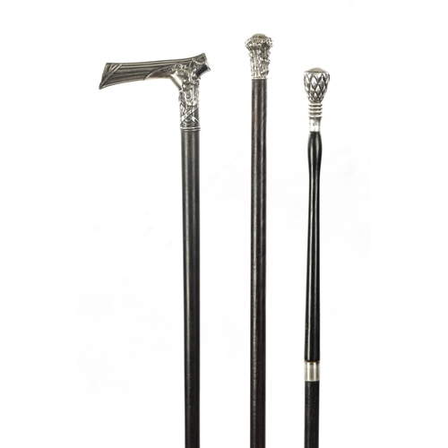 743 - A COLLECTION OF THREE 19TH CENTURY SILVER TOPPED WALKING STICKS comprising chequered, tree trunk and... 