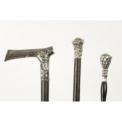 743 - A COLLECTION OF THREE 19TH CENTURY SILVER TOPPED WALKING STICKS comprising chequered, tree trunk and... 