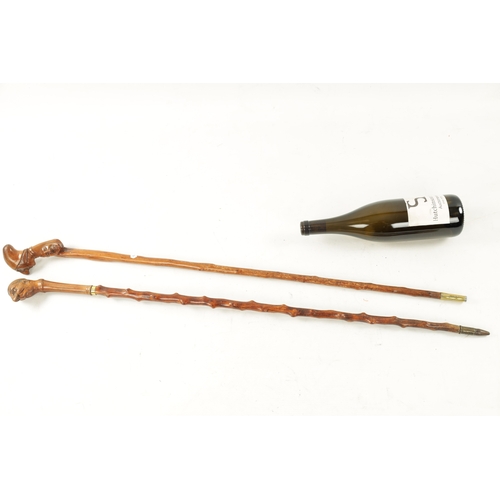 745 - TWO LATE 19TH CENTURY FOLK ART CARVED WALKING CANES one with carved handle formed as mans head and t... 