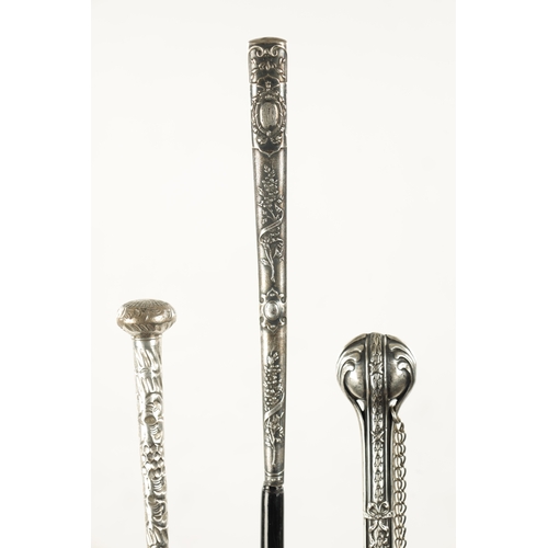 749 - A COLLECTION OF THREE LATE 19TH CENTURY SILVER TOPPED LONG-HANDLED WALKING STICKS of classical flora... 