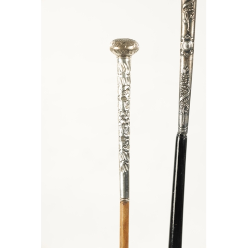 749 - A COLLECTION OF THREE LATE 19TH CENTURY SILVER TOPPED LONG-HANDLED WALKING STICKS of classical flora... 