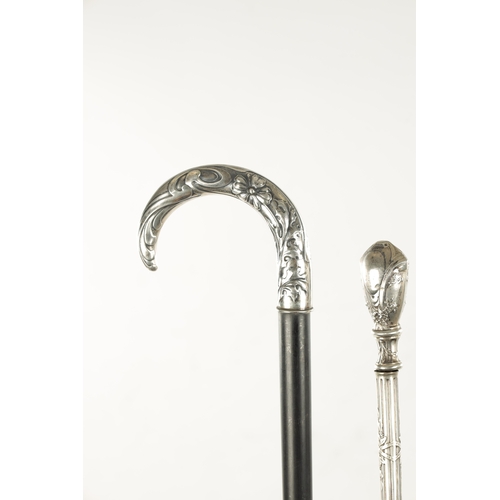 751 - A COLLECTION OF THREE ART NOUVEAU SILVER TOPPED WALKING STICKS two with hook handles, embossed and e... 