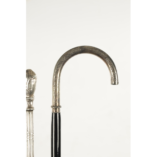 751 - A COLLECTION OF THREE ART NOUVEAU SILVER TOPPED WALKING STICKS two with hook handles, embossed and e... 