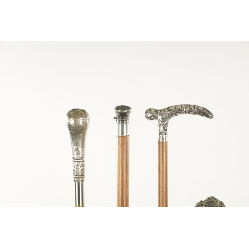 752 - A COLLECTION OF FOUR LATE 19TH CENTURY SILVER AND WHITE METAL TOPPED WALKING STICKS of various desig... 