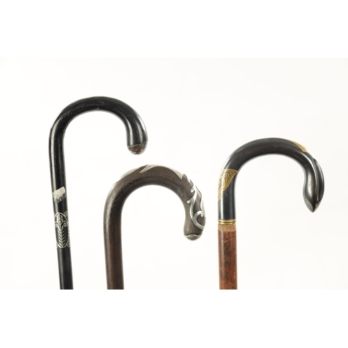 759 - A COLLECTION OF THREE LATE 19TH CENTURY INLAID WALKING STICKS with hook-shaped handles having applie... 