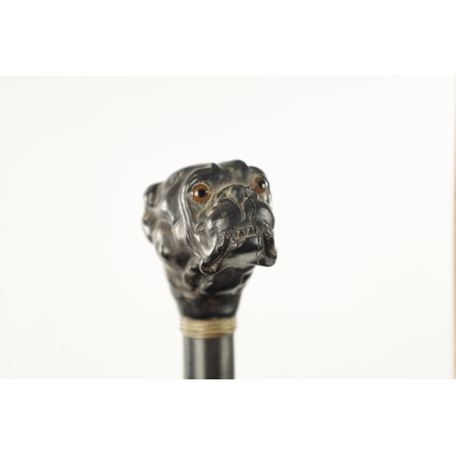 761 - TWO 19TH CENTURY CARVED DOG WALKING CANES one with carved ebony handle modelled as a bulldog with gl... 