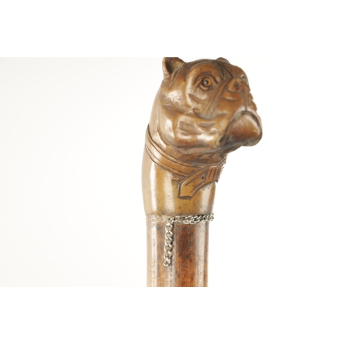 761 - TWO 19TH CENTURY CARVED DOG WALKING CANES one with carved ebony handle modelled as a bulldog with gl... 