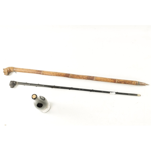 761 - TWO 19TH CENTURY CARVED DOG WALKING CANES one with carved ebony handle modelled as a bulldog with gl... 