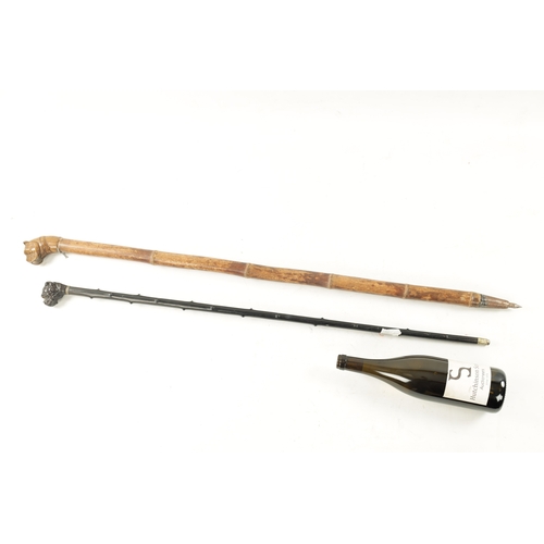 761 - TWO 19TH CENTURY CARVED DOG WALKING CANES one with carved ebony handle modelled as a bulldog with gl... 