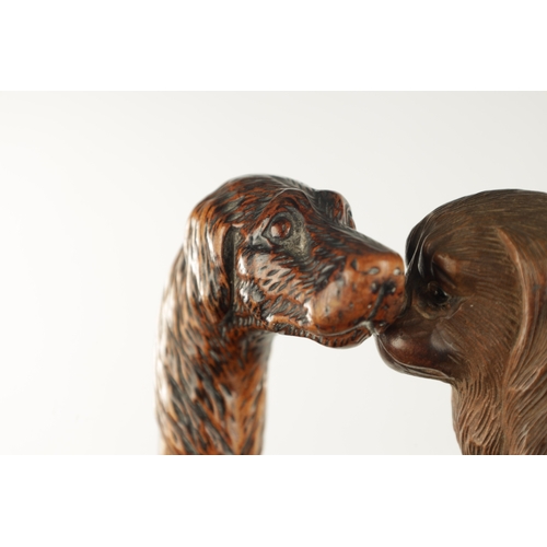 769 - TWO LATE 19TH CENTURY CARVED DOG'S HEAD WALKING STICKS one modelled as a spaniel with glass eyes, th... 