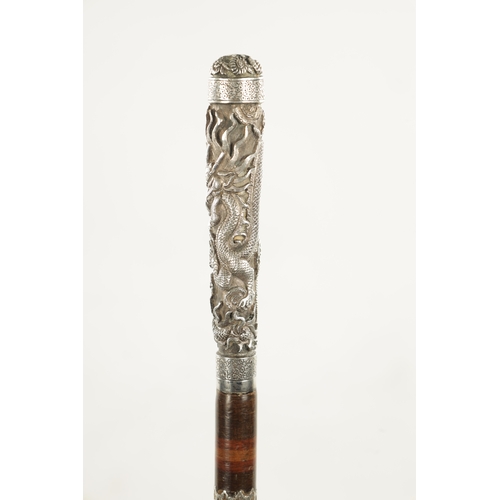 773 - A LATE 19TH CENTURY CHINESE SILVER WALKING STICK with engraved dragon to the handle, on a segmented ... 