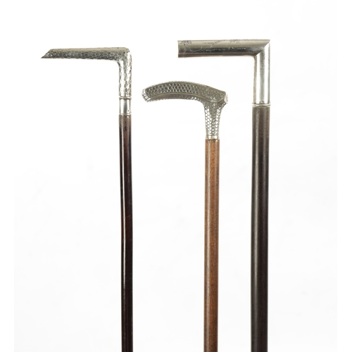 774 - A COLLECTION OF THREE LATE 19TH CENTURY SILVER TOPPED WALKING STICKS two with scaley patterns, the o... 