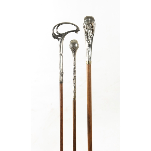 777 - A COLLECTION OF THREE ART NOUVEAU SILVER TOPPED WALKING STICKS (91cm long)