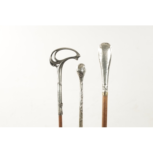 777 - A COLLECTION OF THREE ART NOUVEAU SILVER TOPPED WALKING STICKS (91cm long)