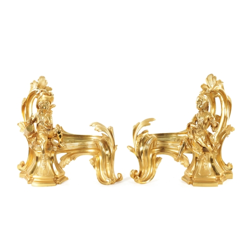 1003 - A PAIR OF 19TH CENTURY GILT ORMOLU CHENETS OF ROCOCO CHIPPENDALE DESIGN the leaf swirled bodies moun... 