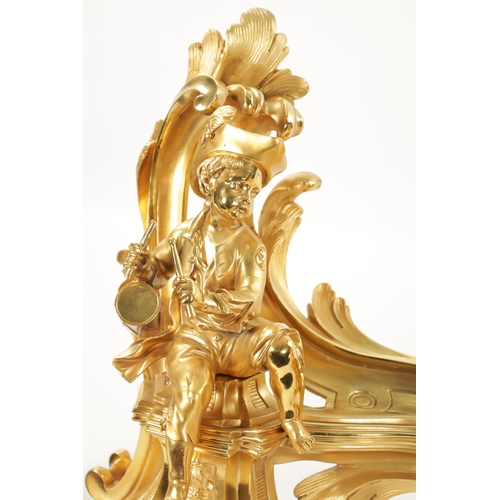 1003 - A PAIR OF 19TH CENTURY GILT ORMOLU CHENETS OF ROCOCO CHIPPENDALE DESIGN the leaf swirled bodies moun... 