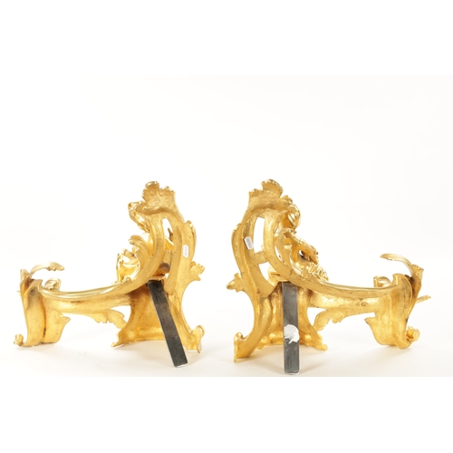 1003 - A PAIR OF 19TH CENTURY GILT ORMOLU CHENETS OF ROCOCO CHIPPENDALE DESIGN the leaf swirled bodies moun... 