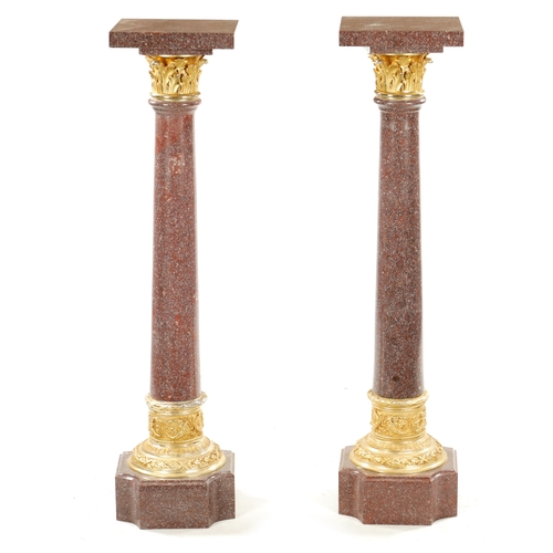 1004 - A PAIR OF 20TH CENTURY PORPHYRY TYPE AND ORMOLU MOUNTED COLUMNS with tapering stems and square bases... 