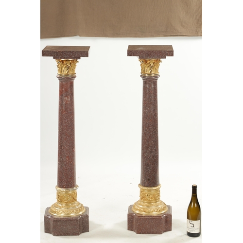 1004 - A PAIR OF 20TH CENTURY PORPHYRY TYPE AND ORMOLU MOUNTED COLUMNS with tapering stems and square bases... 