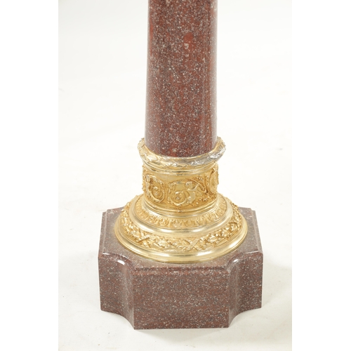 1004 - A PAIR OF 20TH CENTURY PORPHYRY TYPE AND ORMOLU MOUNTED COLUMNS with tapering stems and square bases... 