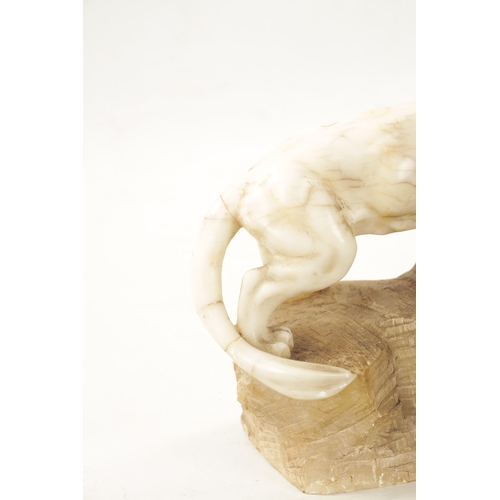 1012 - A 19TH CENTURY CARVED ALABASTER SCULPTURE OF TWO LIONS mounted on a naturalistic base (55cm wide)