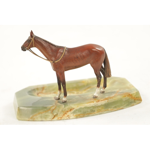 1021 - AN EARLY 20TH CENTURY COLD PAINTED BRONZE AND ONYX DESK TIDY modelled as a standing horse. (12cm hig... 