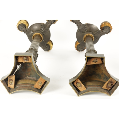 1023 - A PAIR OF REGENCY BRONZE AND ORMOLU THREE BRANCH CANDELABRA having leaf cast decoration throughout w... 