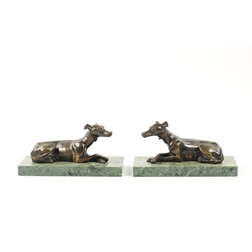 1029 - A PAIR OF FRENCH 19TH CENTURY PATINATED BRONZE SCULPTURES modelled as recumbent greyhounds mounted o... 