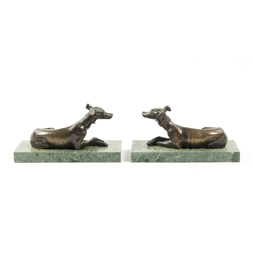 1029 - A PAIR OF FRENCH 19TH CENTURY PATINATED BRONZE SCULPTURES modelled as recumbent greyhounds mounted o... 