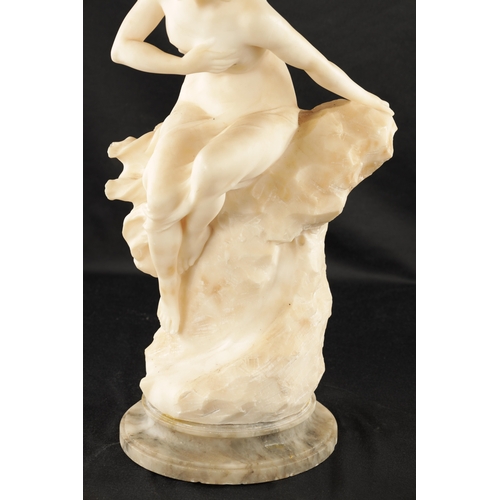 1037 - AN ART NOUVEAU CARVED ALABASTER FIGURE OF A SEMI-NUDE LADY seated on a naturalistic base. (49cm high... 