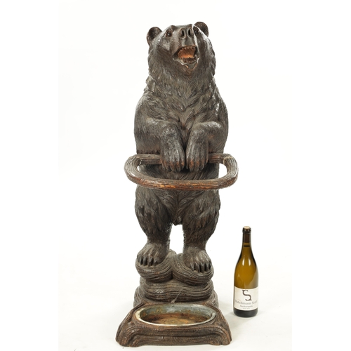 1040 - A LATE 19TH CENTURY CARVED BLACK FOREST BEAR STICK STAND Modelled as a standing bear with inset glas... 