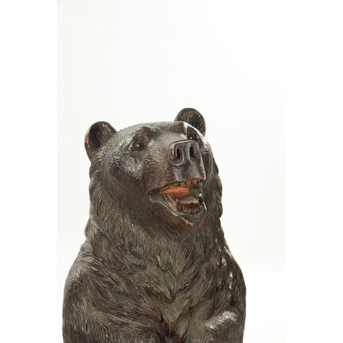 1040 - A LATE 19TH CENTURY CARVED BLACK FOREST BEAR STICK STAND Modelled as a standing bear with inset glas... 